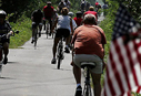 People riding bikes along a paved road.